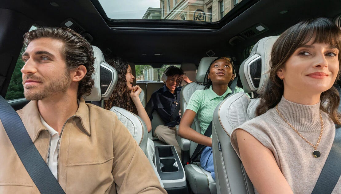 An interior reverse shot of the INFINITI QX60 interior, each seat occupied comfortably by a passenger.