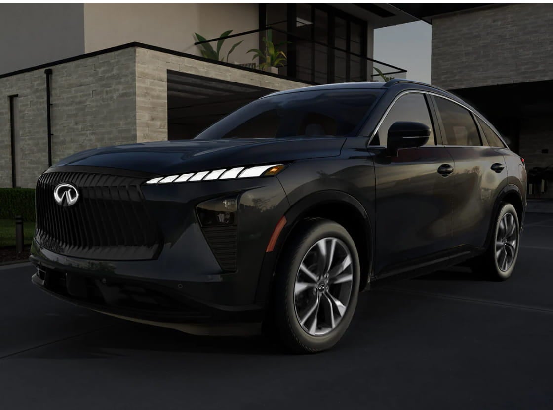 A sleek black Infiniti SUV is parked in front of a modern, minimalist house.
